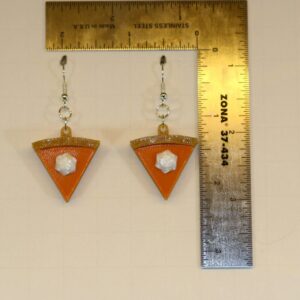 Pair of earrings shaped like a slice of pumpkin pie with golden crust and orange filling.