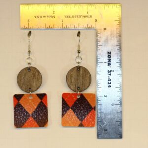 Wood and faux leather print earrings with mixed textures.