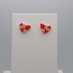 Pair of stud earrings featuring nested layered heart designs.