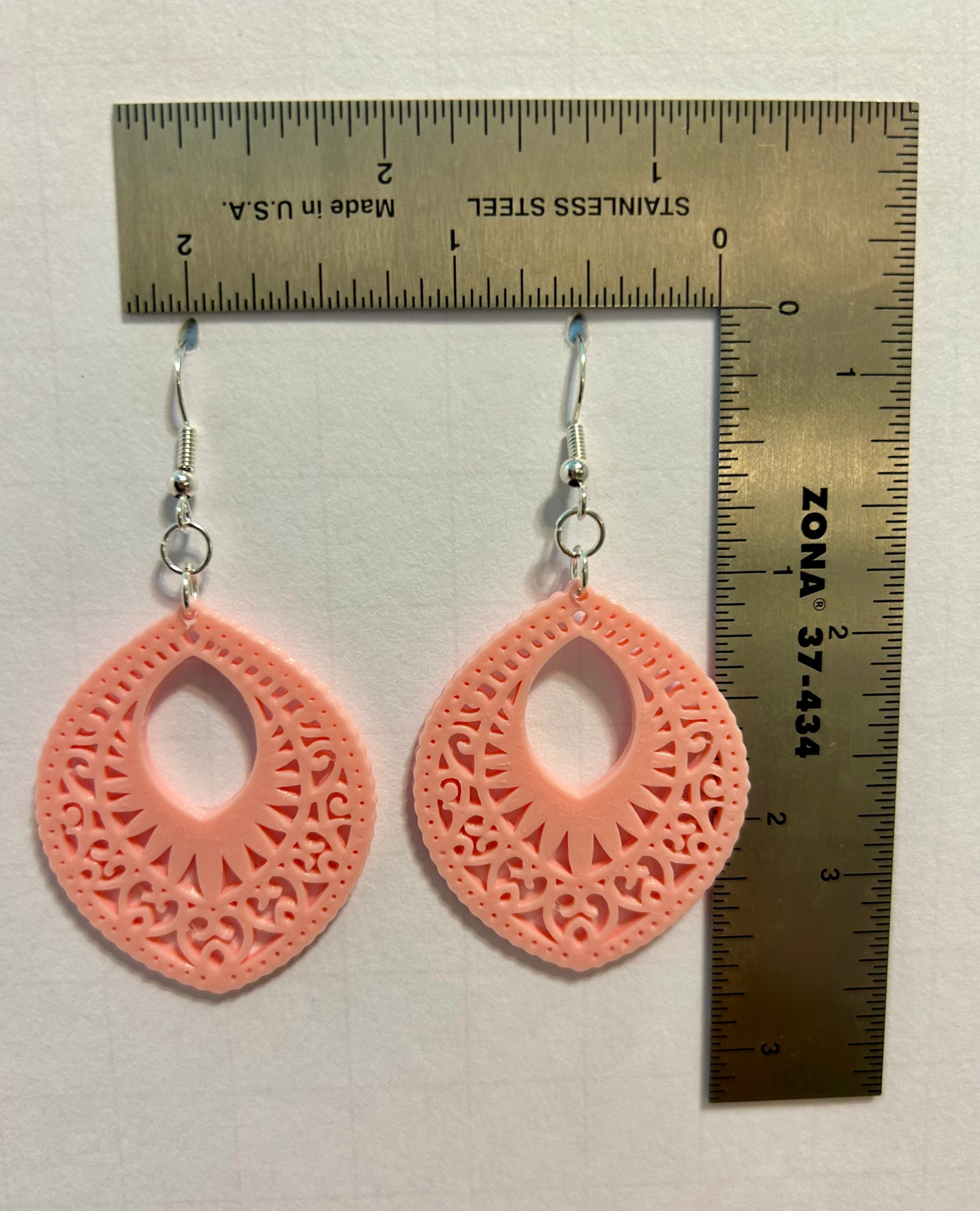 Lace-patterned boho earrings with delicate cutout design.