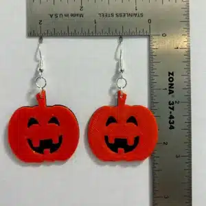Orange pumpkin earrings with carved jack o’ lantern faces
