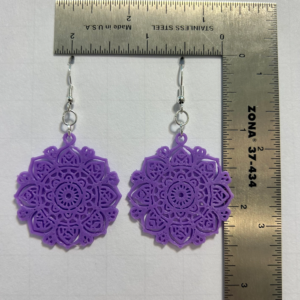 Round mandala earrings with intricate boho detailing.