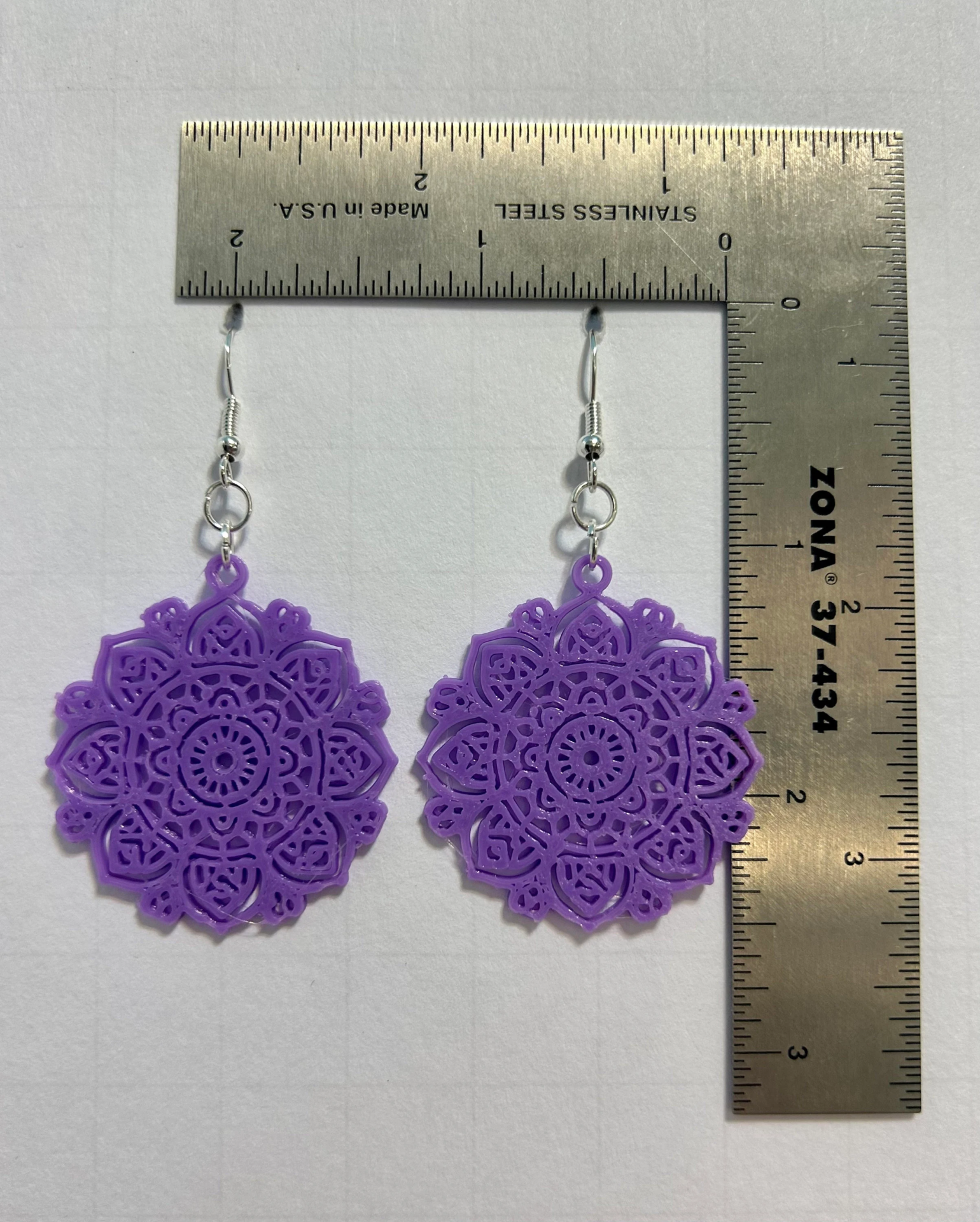 Round mandala earrings with intricate boho detailing.