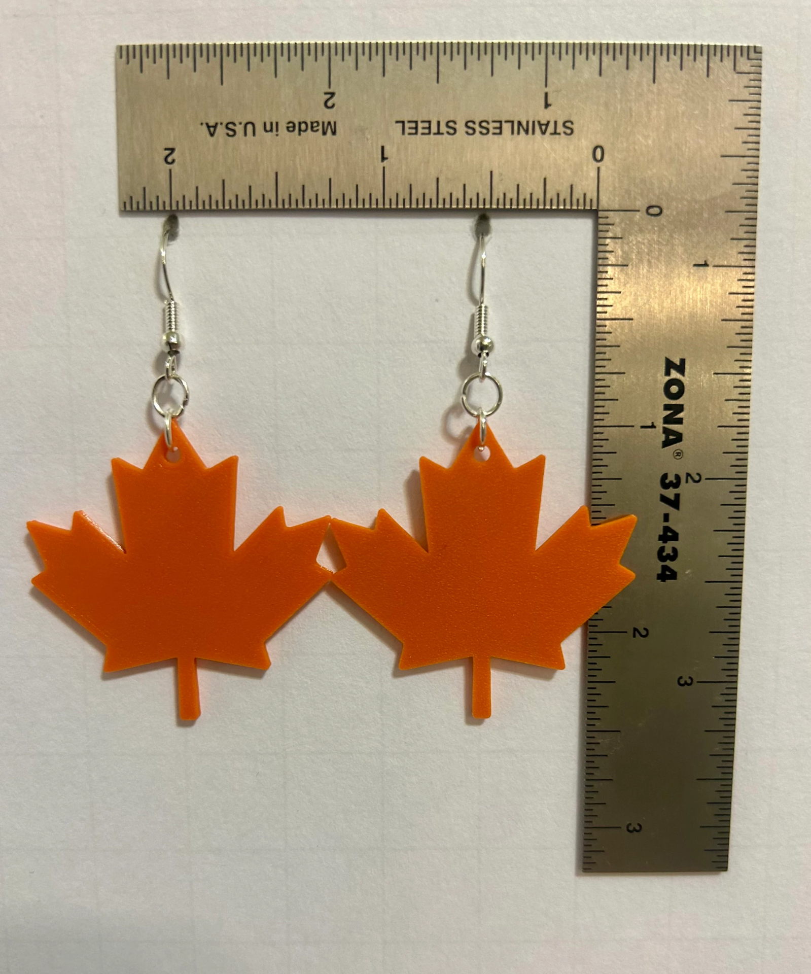 Maple leaf earrings with detailed leaf design and fall-inspired tones.Maple leaf earrings with detailed leaf design and fall-inspired tones.