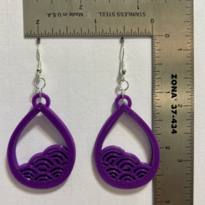 Earrings with curved wave design symbolizing ocean flow.