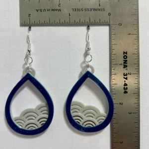 Earrings with curved wave design symbolizing ocean flow.