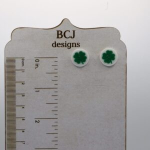 Pair of small stud earrings featuring green clover medallions.