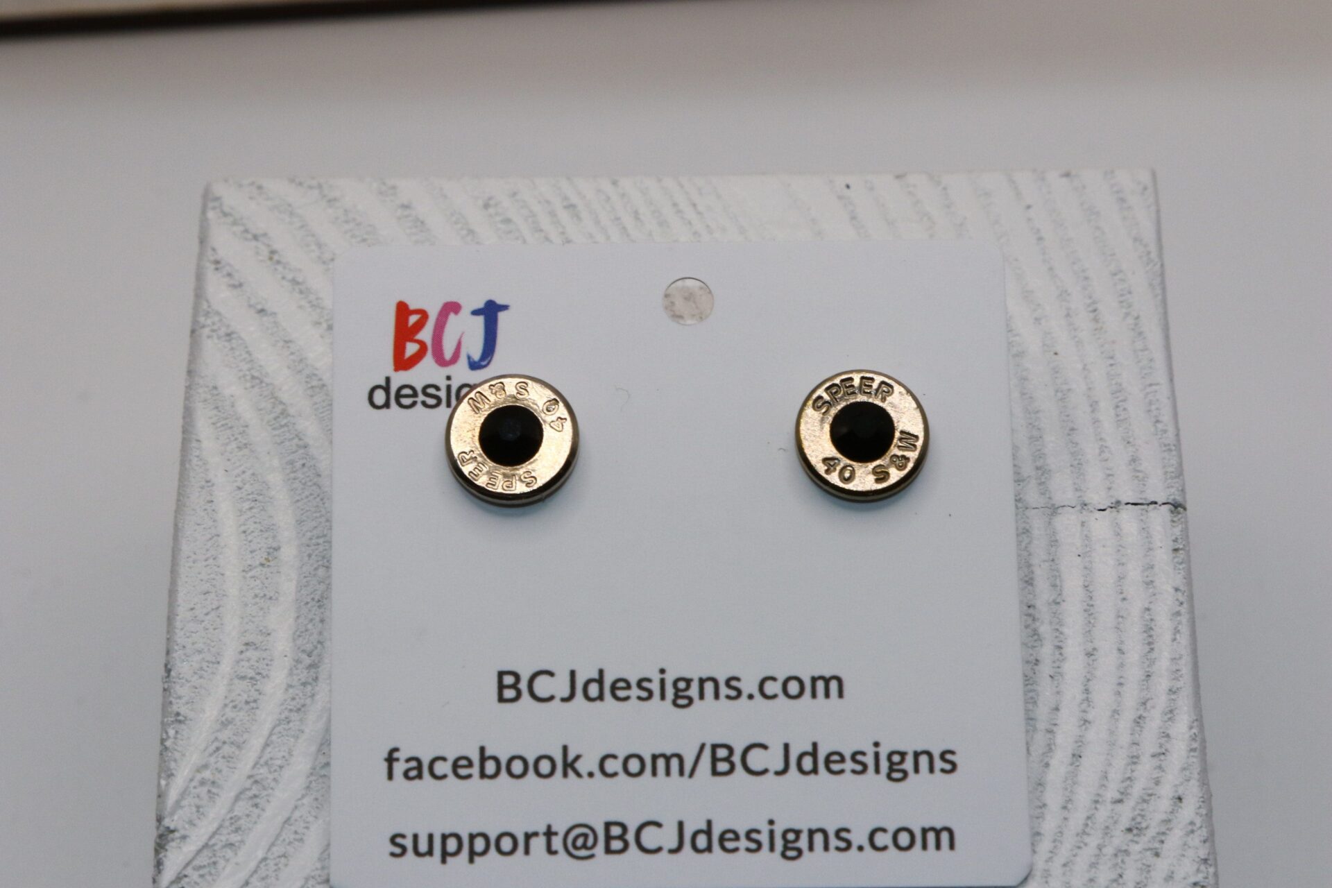 bullet slice earring with a gem in the center