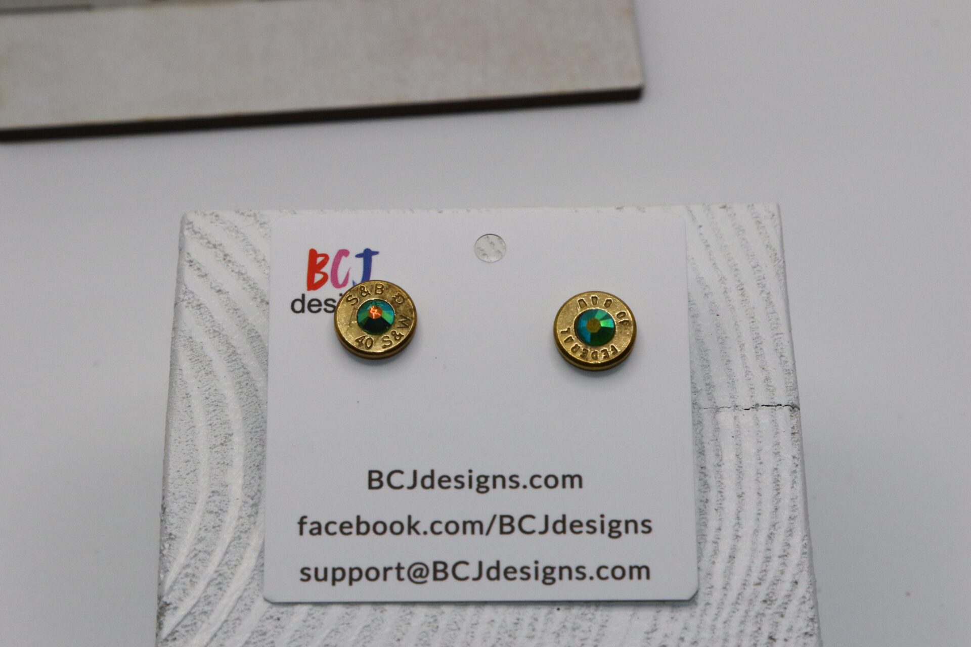 bullet slice earring with a gem in the center
