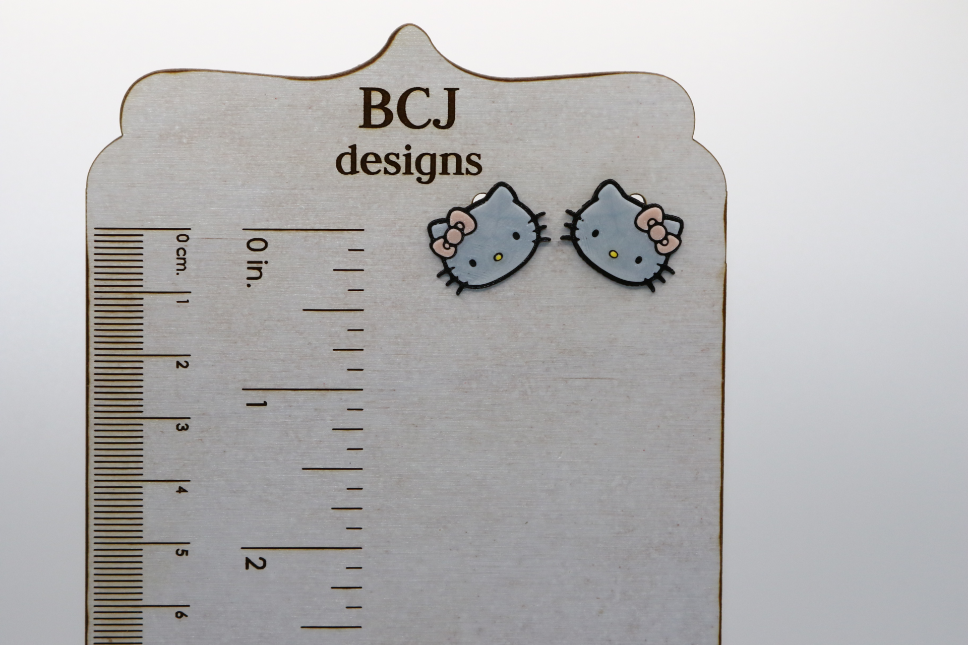 Hello Kitty stud earrings featuring classic face design.
