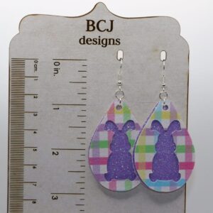 Glitter-covered bunny-shaped earrings in bright pastel colors.