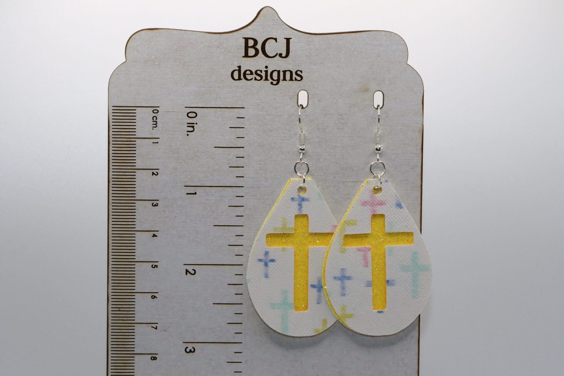 Faux leather cross-shaped earrings in a minimalist Easter design.
