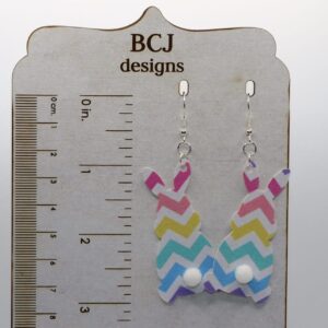Faux leather bunny earrings with small fluffy tail accents.