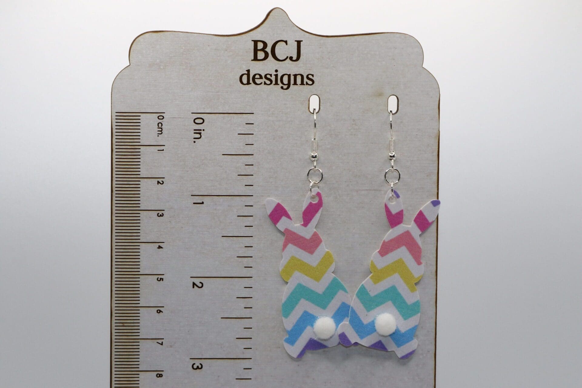 Faux leather bunny earrings with small fluffy tail accents.