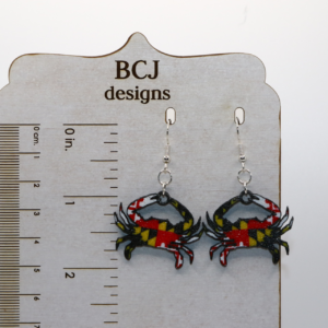 Maryland flag crab earrings with red, yellow, and black pattern.