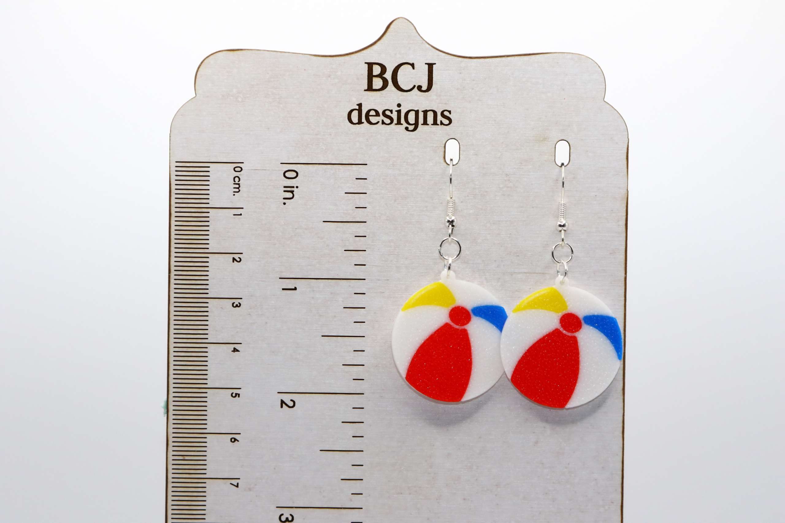pair of beach ball earrings on a display