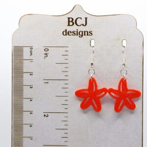 Pair of earrings shaped like detailed starfish in natural colors.