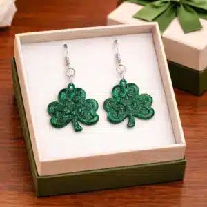 Pair of earrings featuring a swirling green