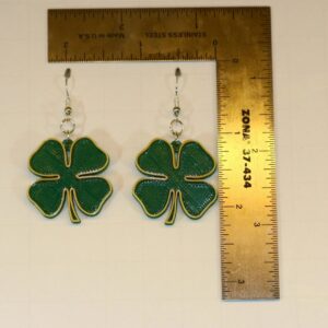 Pair of earrings featuring green clovers with gold accent details.