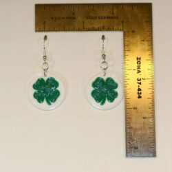 Pair of earrings shaped like green and white clovers.