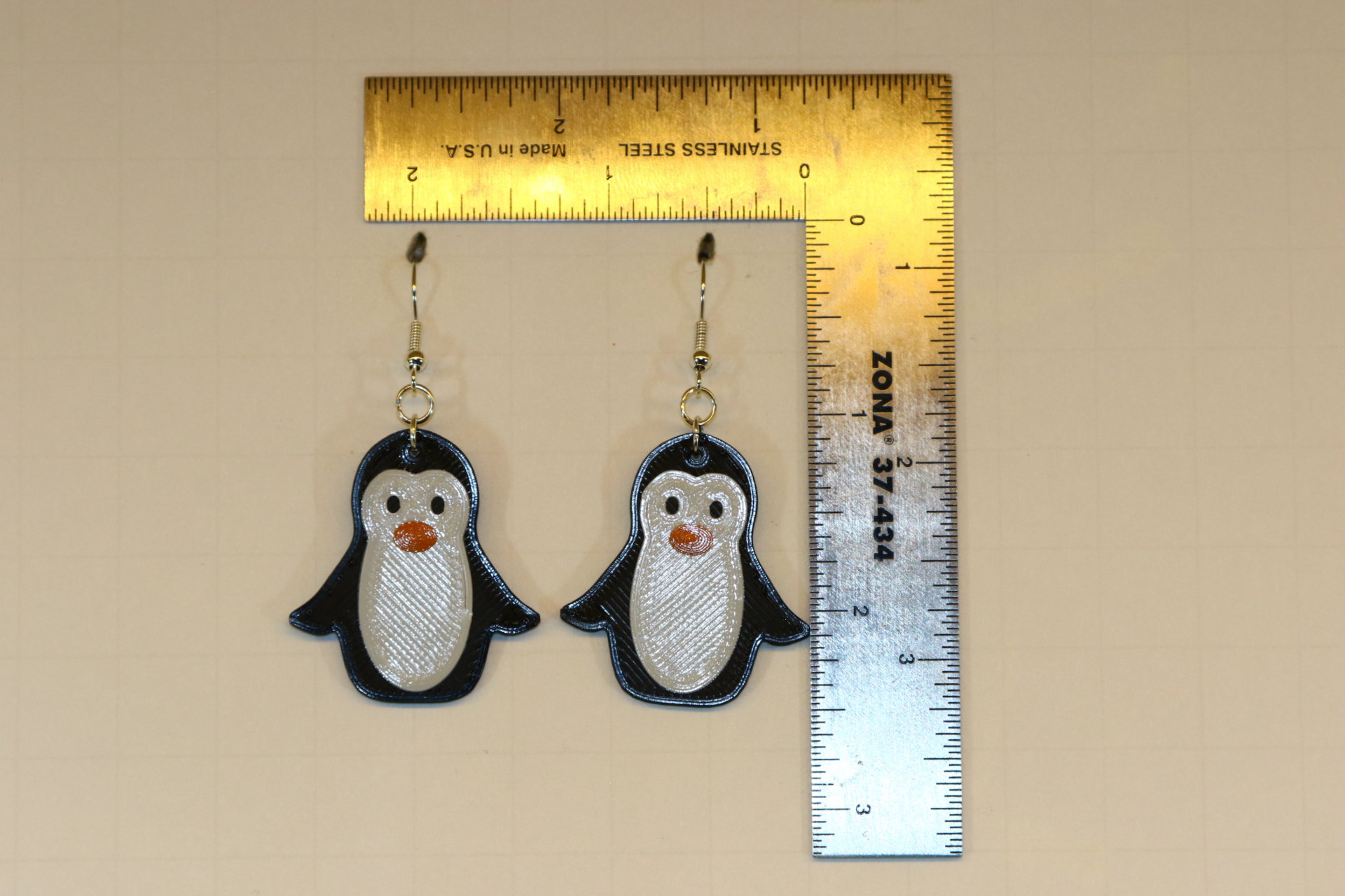 Penguin earrings featuring cute black-and-white penguin design.