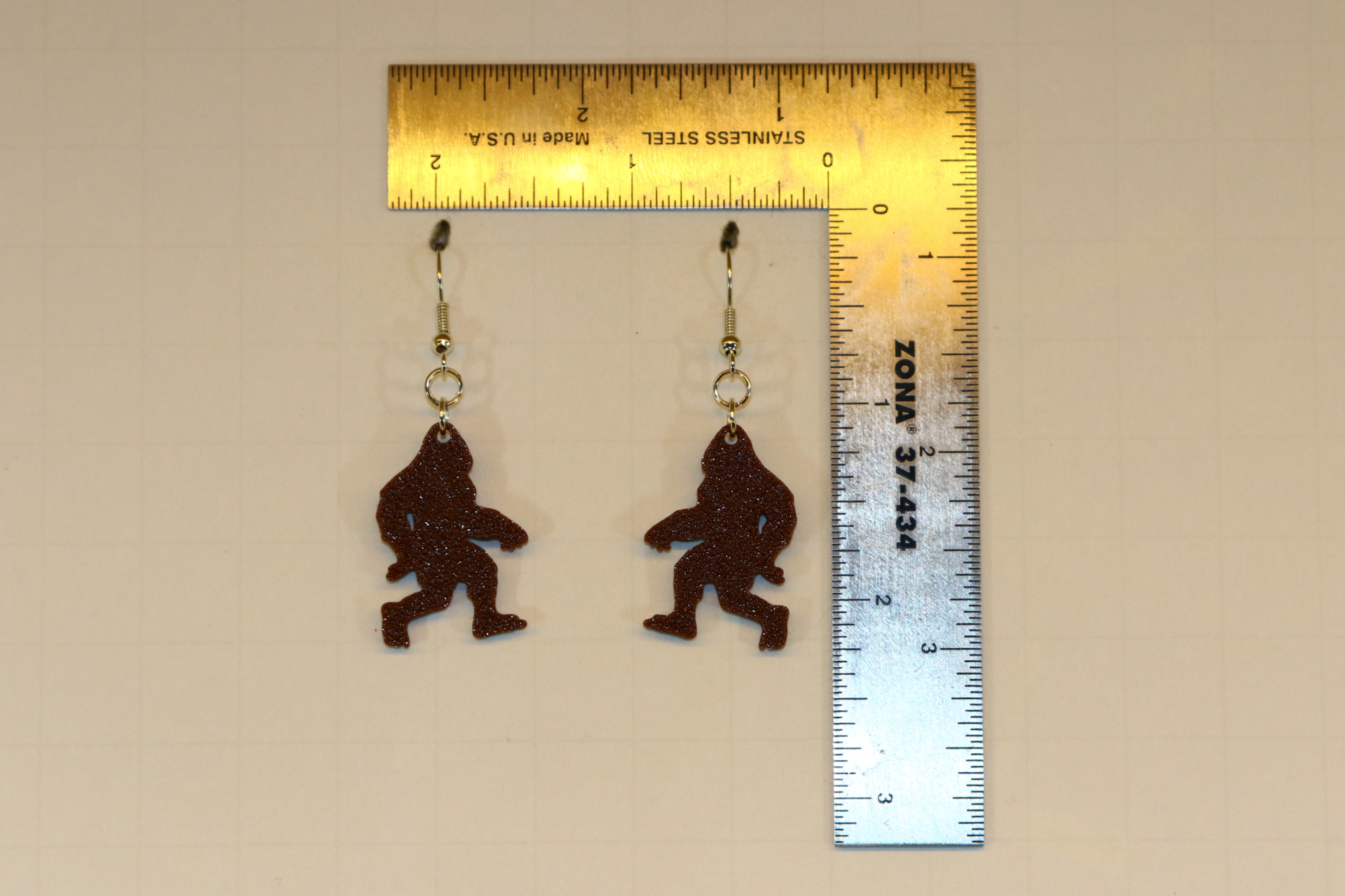 Bigfoot earrings featuring silhouette of forest creature.
