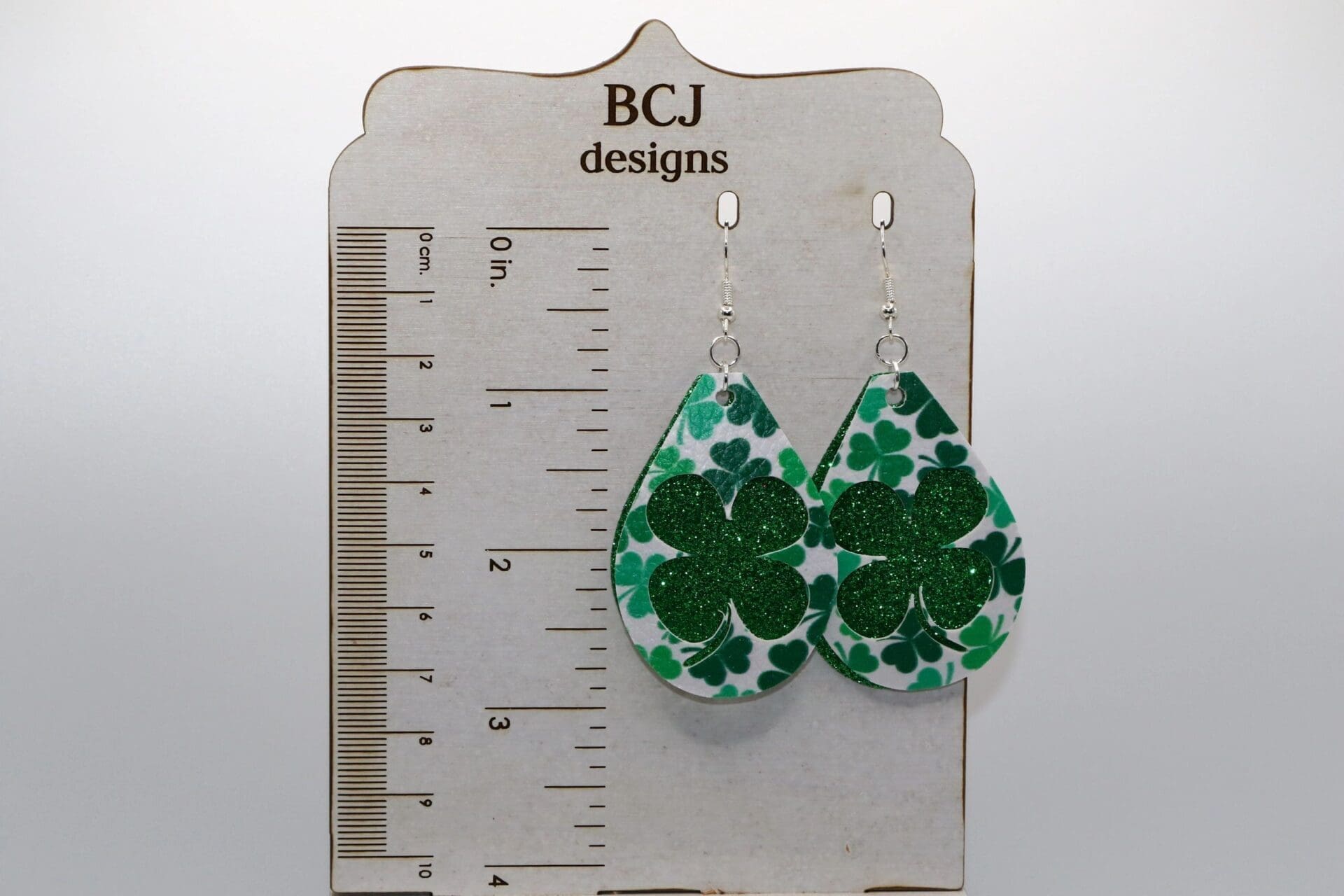 Pair of earrings shaped like bright green faux leather clovers.