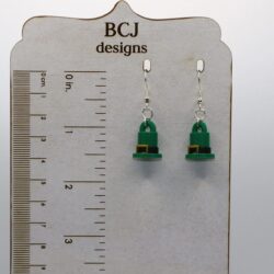 Pair of earrings shaped like green leprechaun top hats with gold buckles.