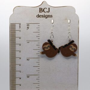 Sloth earrings featuring hanging sloth design.