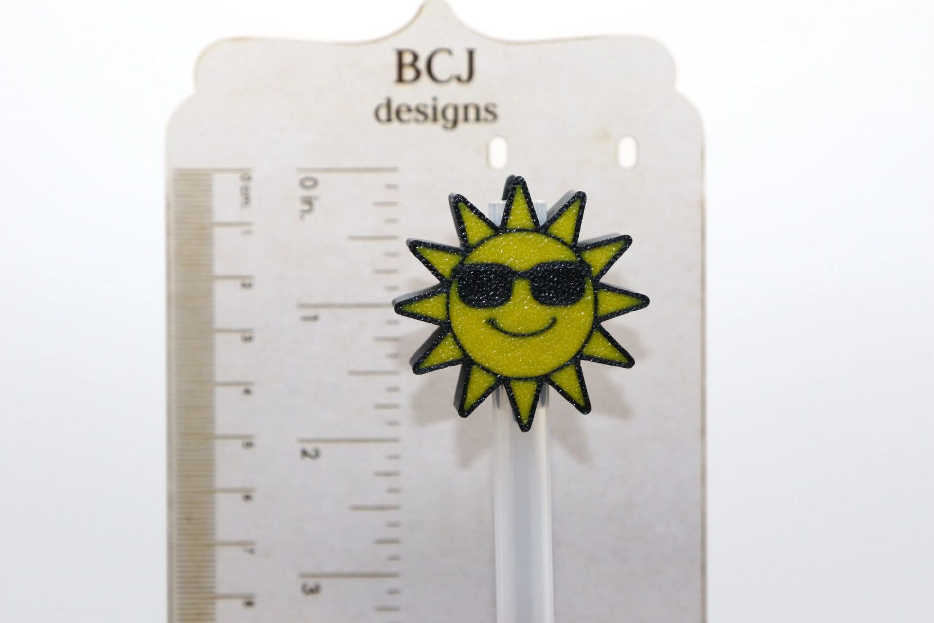 Sunshine straw topper with bright yellow sun design.