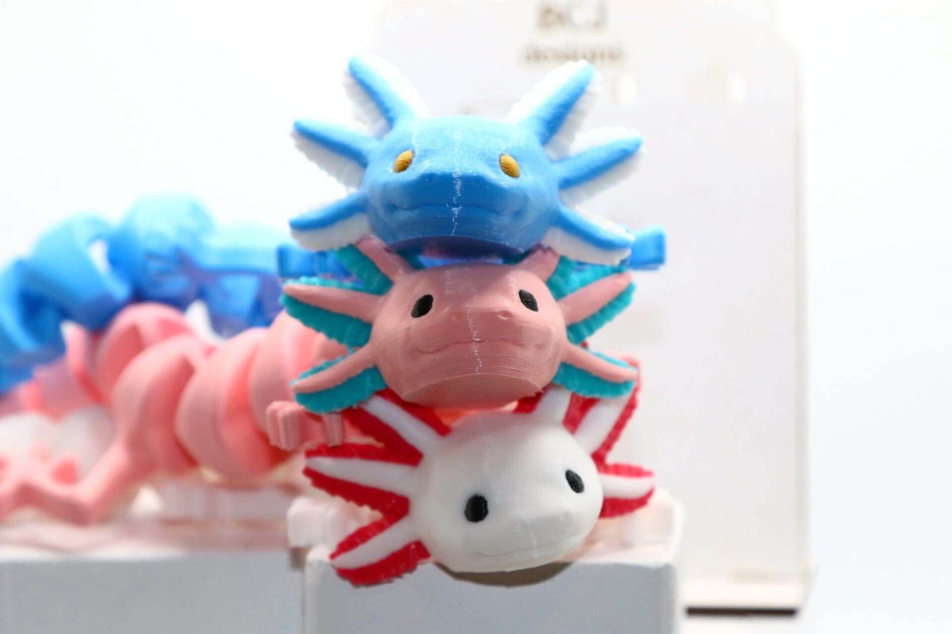 Axolotl fidget toy with smiling face and flexible limbs.