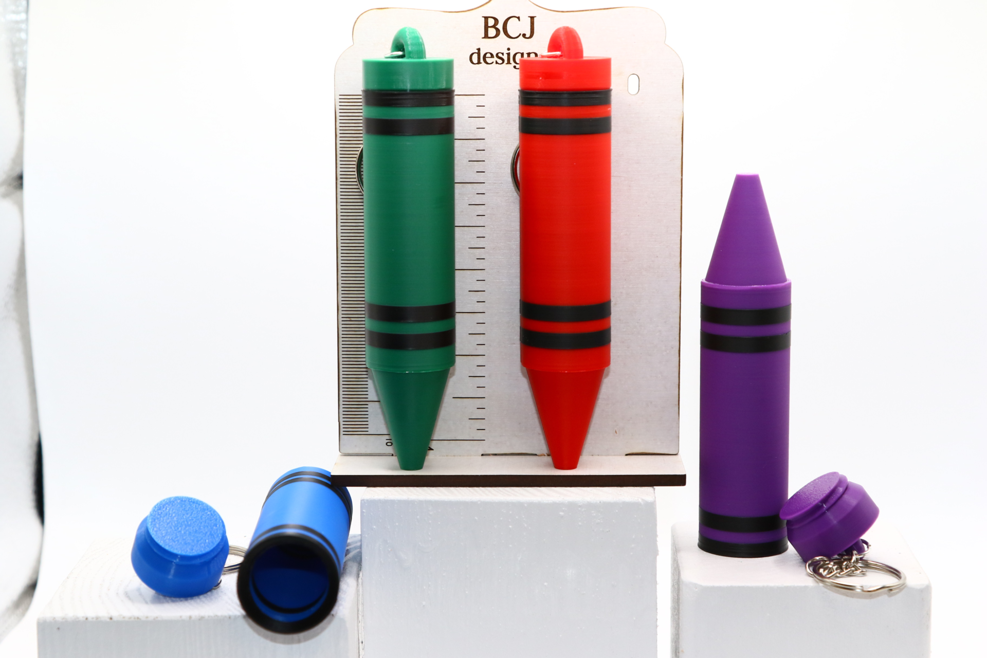 Crayon-shaped chapstick holder keychain in bright colorsCrayon-shaped chapstick holder keychain in bright colors