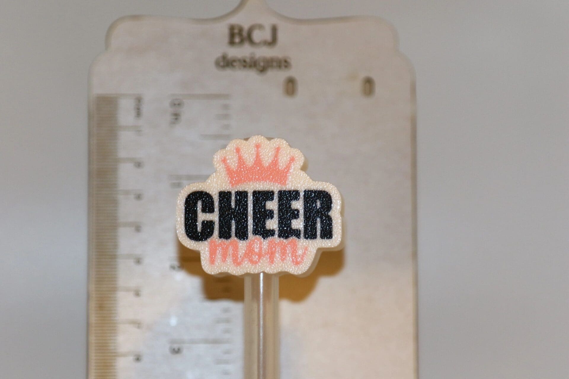 Cheer Mom themed straw topper clipped to a straw