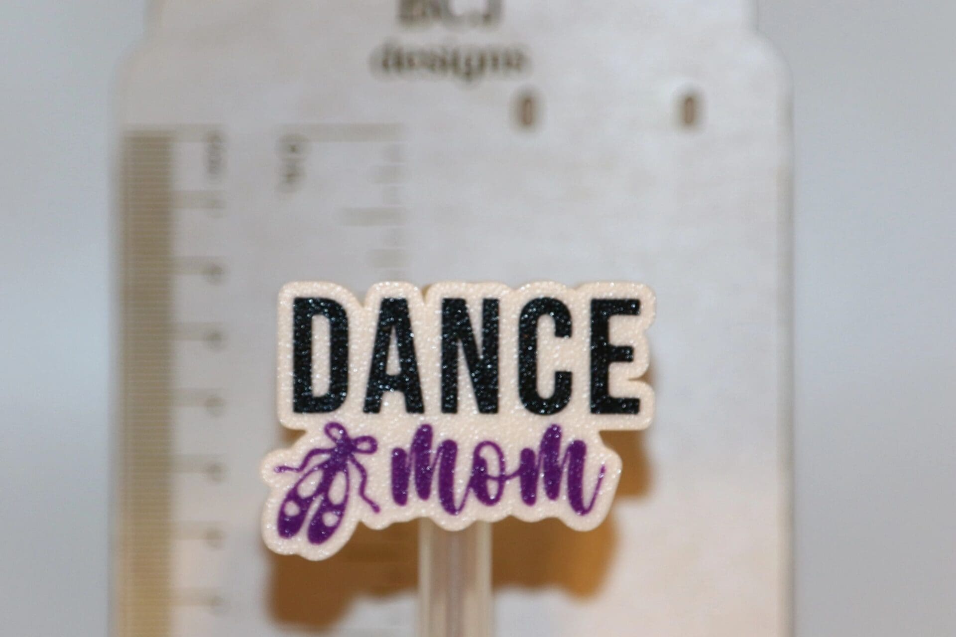 Dance Mom straw topper clipped to a straw