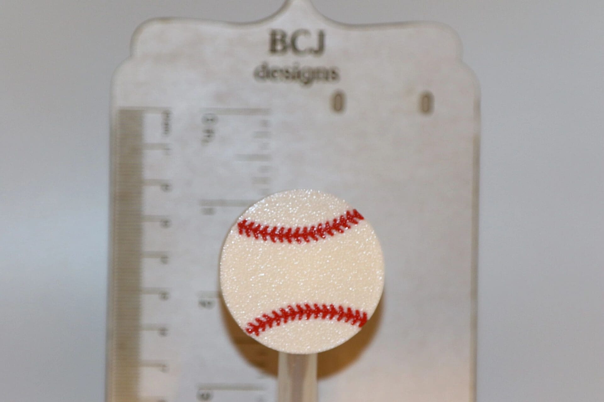 Baseball-themed straw topper attached to a straw