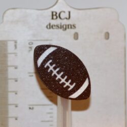 Football-shaped straw topper attached to a drinking straw