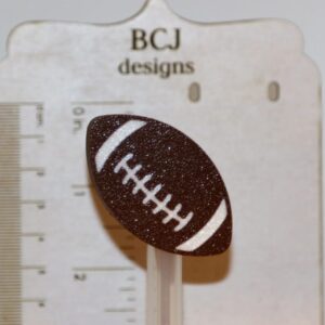 Football-shaped straw topper attached to a drinking straw