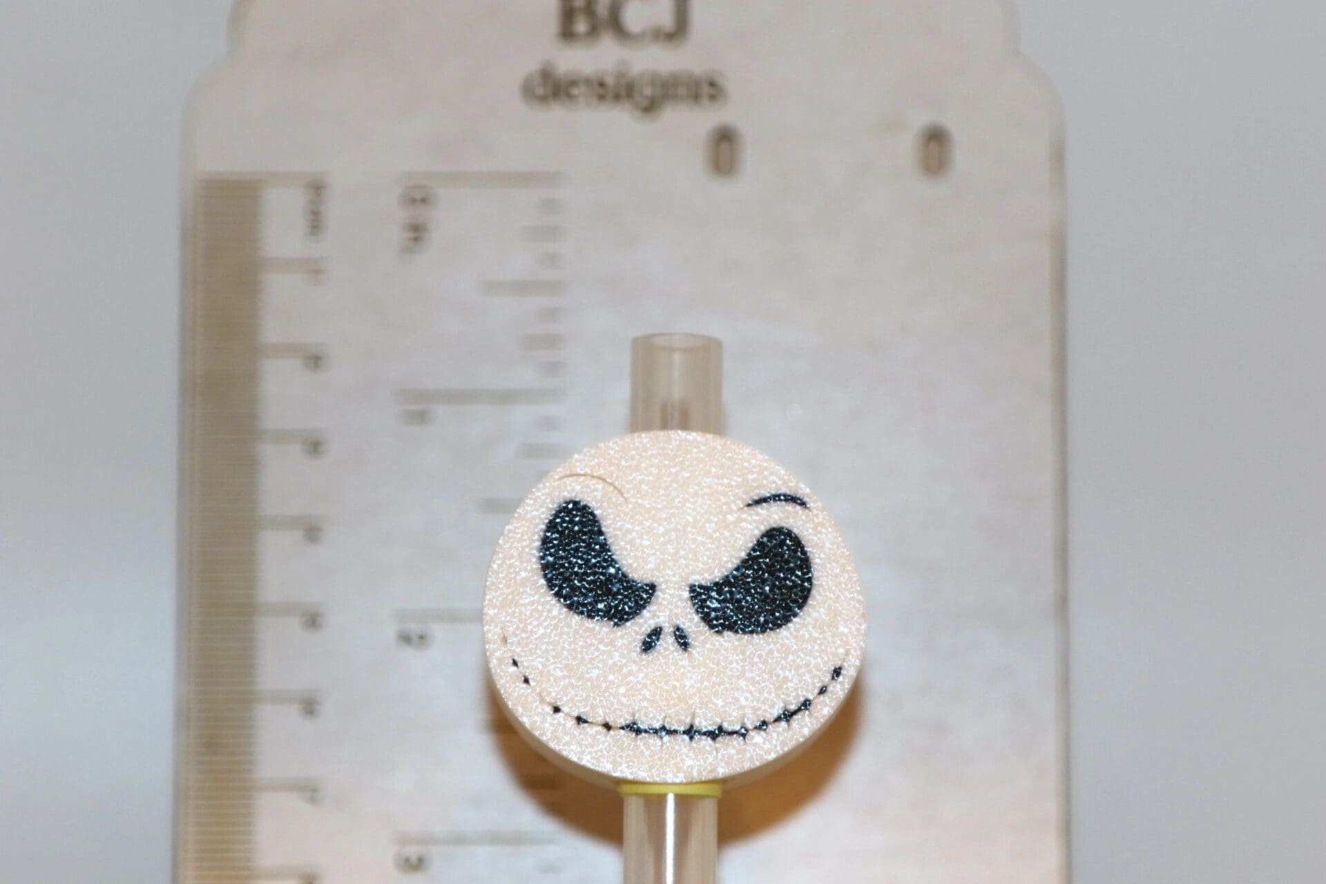 Jack Skellington straw topper with white skull design.