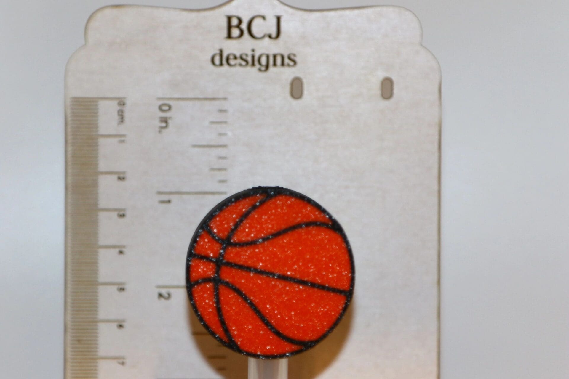 Basketball-shaped straw topper on a straw