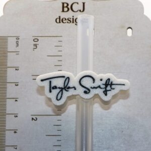 Taylor Swift signature straw topper clipped to a straw