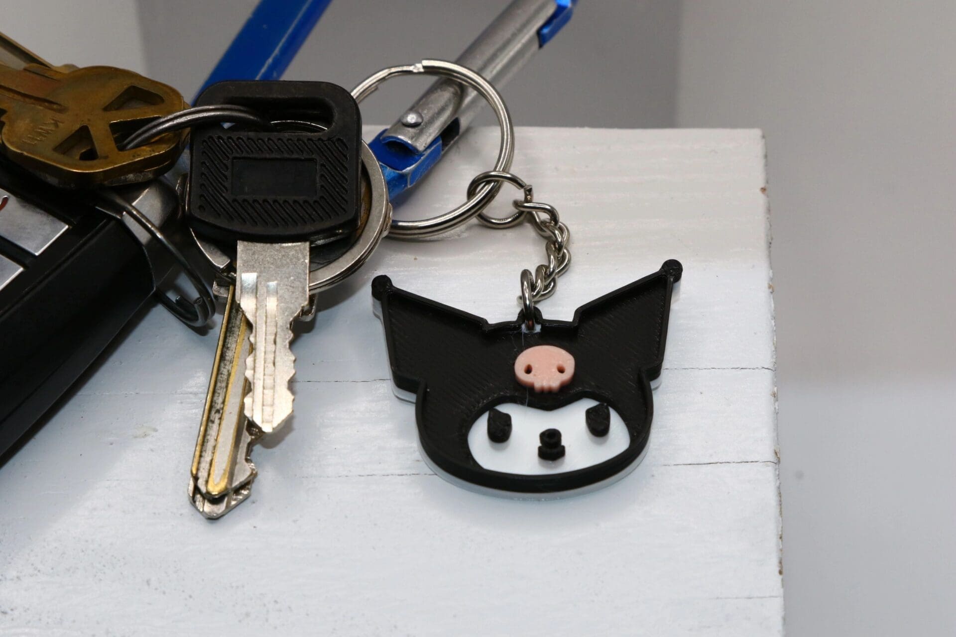 Kuromi keychain with black hood and pink skull