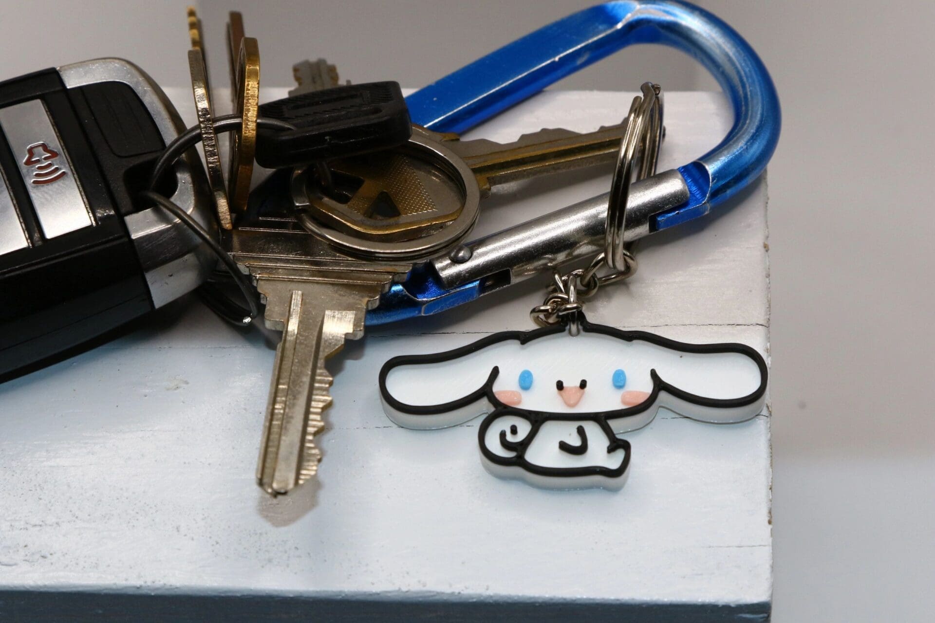 Cinnamoroll keychain with floppy ears and smiling face