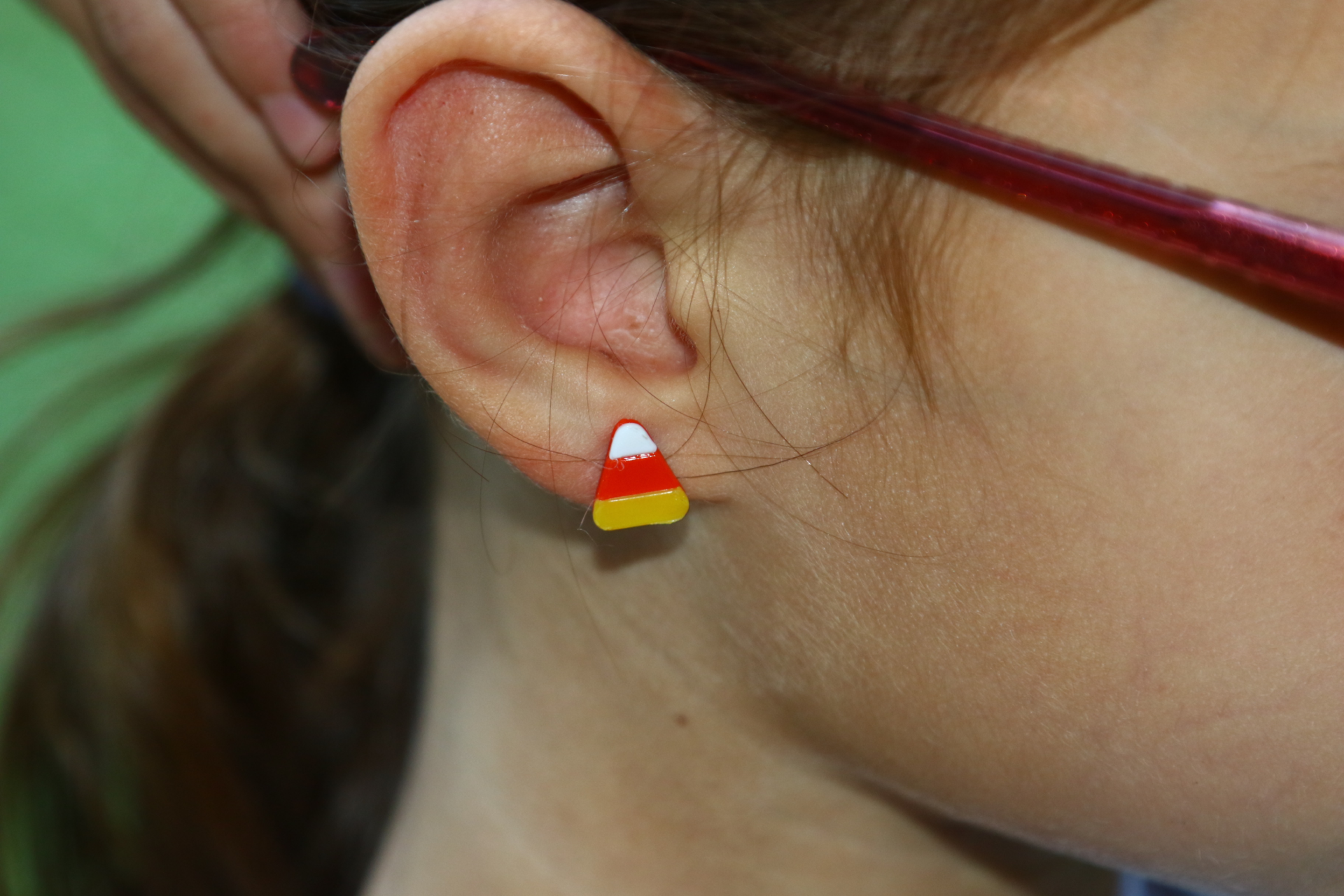 Candy corn stud earrings in traditional orange, yellow, and white colors