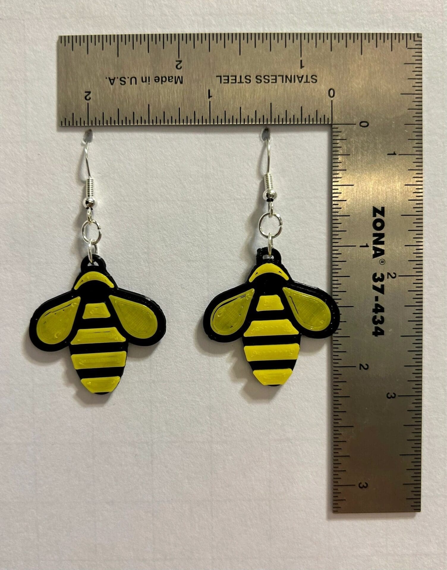 Bumble bee earrings featuring yellow and black bee design.