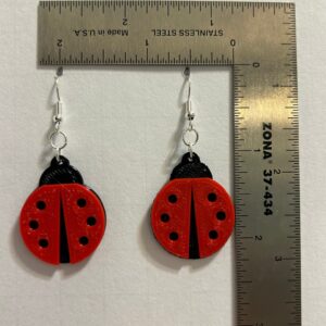 Ladybug earrings with red-and-black spotted design.