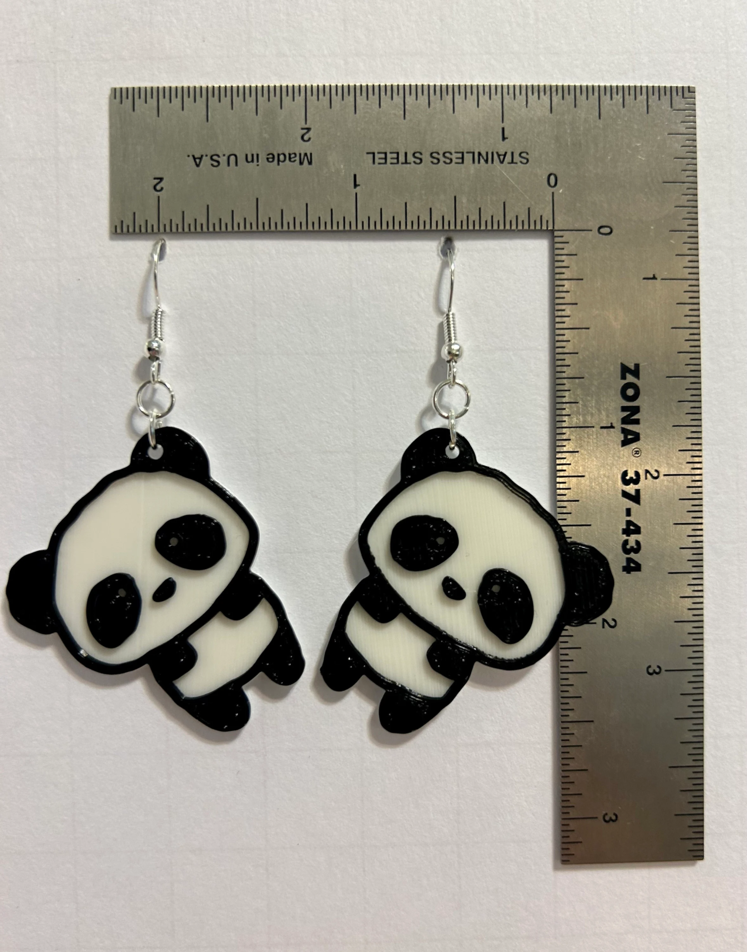 Panda earrings featuring black-and-white panda design.