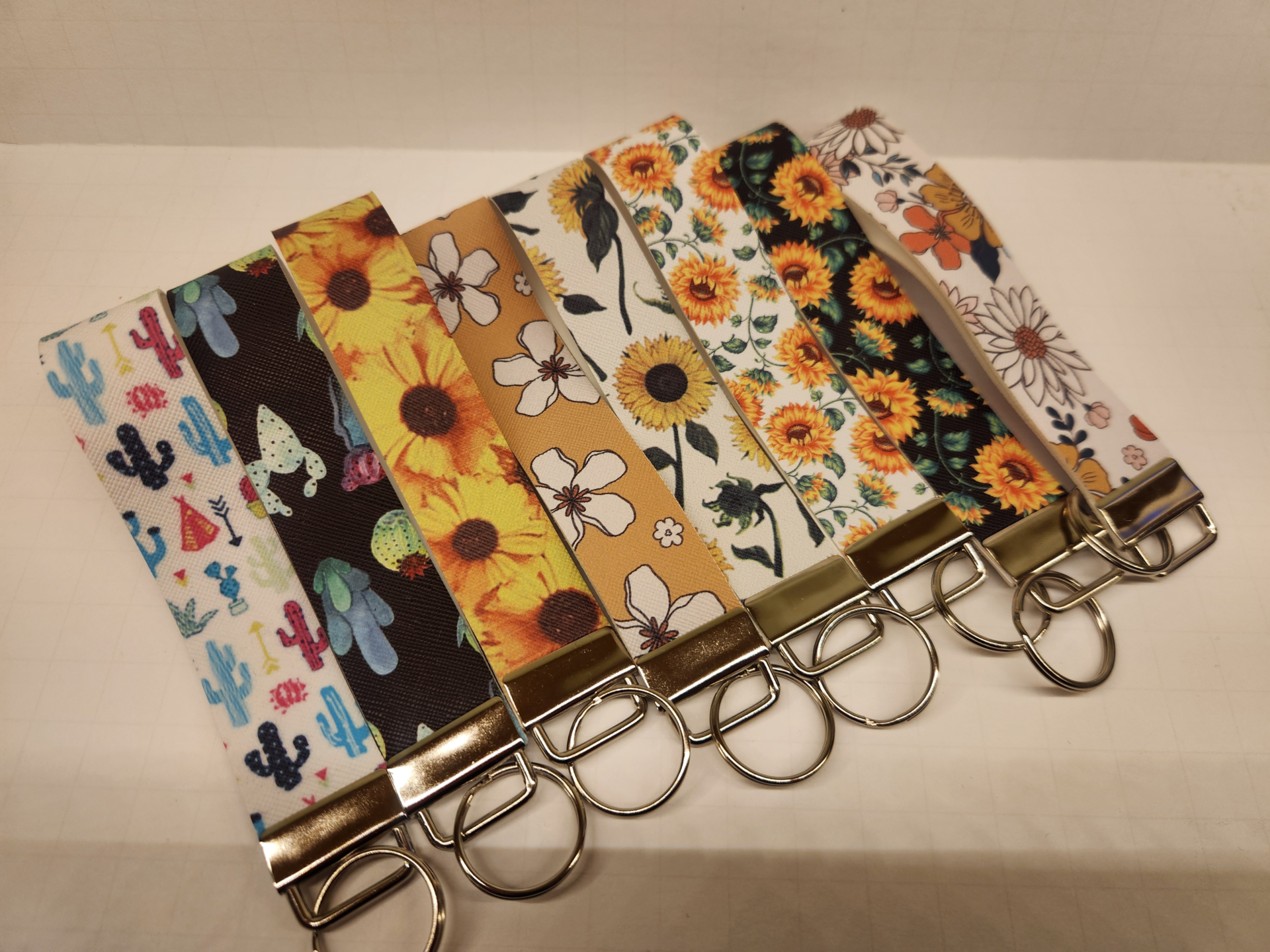 Lineup of Floral wristlets collection showing multiple colorful floral designs