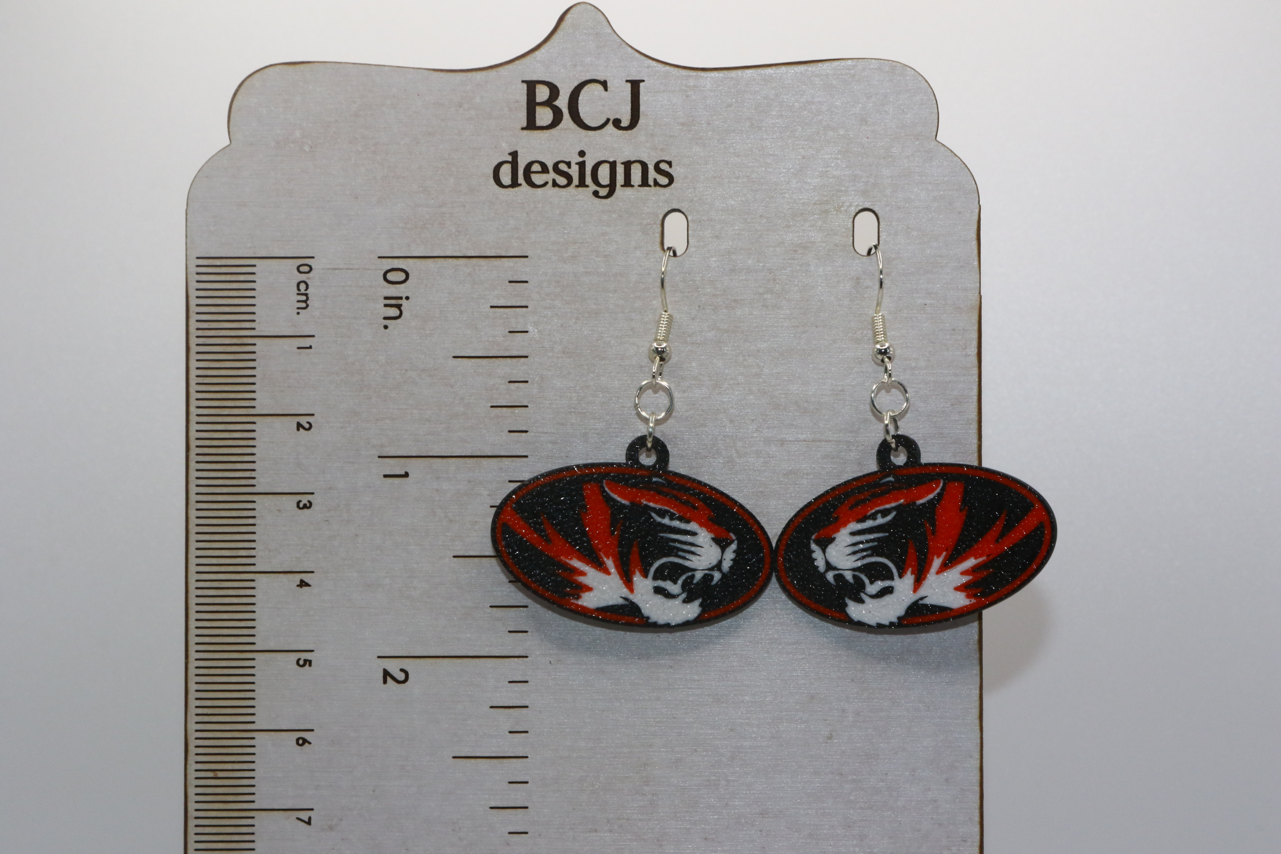 Rising Sun Tigers logo earrings in black and orange team colors