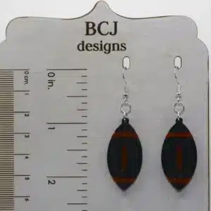 Black and orange football earrings representing Rising Sun High School spirit