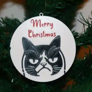 Grumpy Cat Christmas ornament with text “Merry Christmas,” colorful holiday theme.